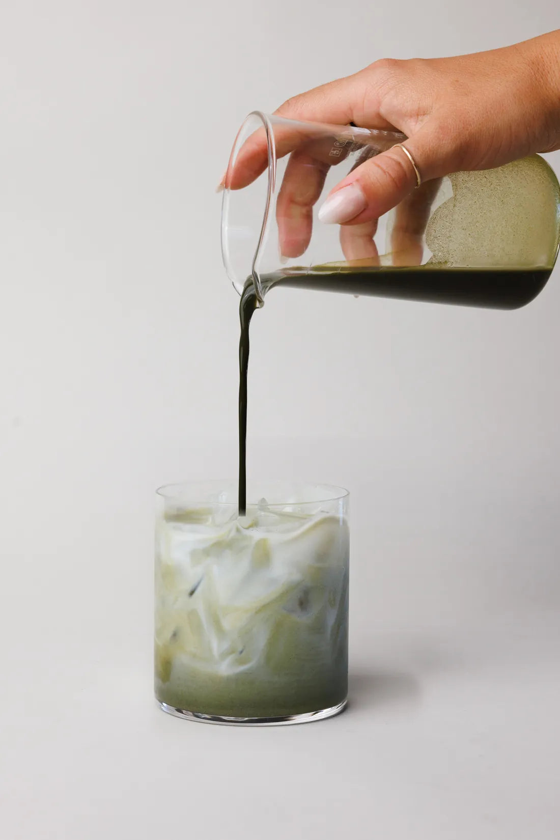Ascend matcha poured over milk in a glass
