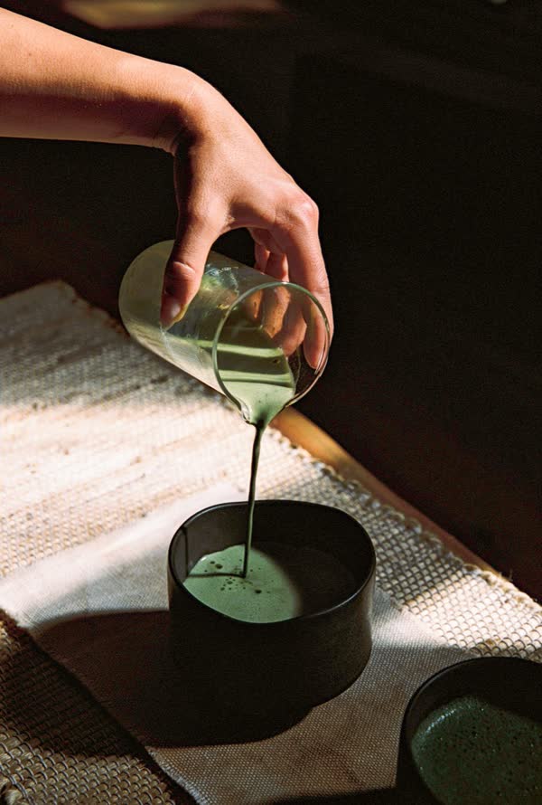 Ascend Matcha being poured into a handmade ceramic cup